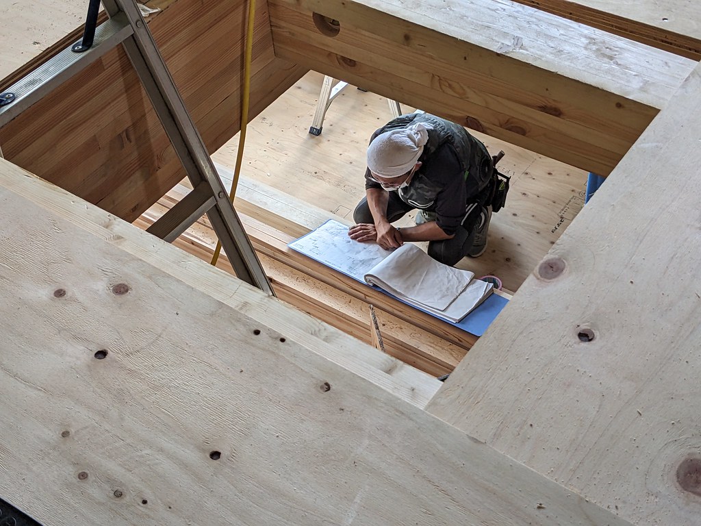 図面を見つめる大工さん